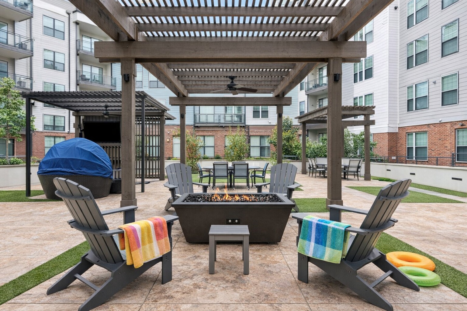 Outdoor fire pit surrounded by lounge chairs