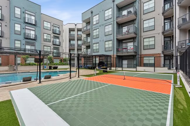 Outdoor pickleball court beside the pool