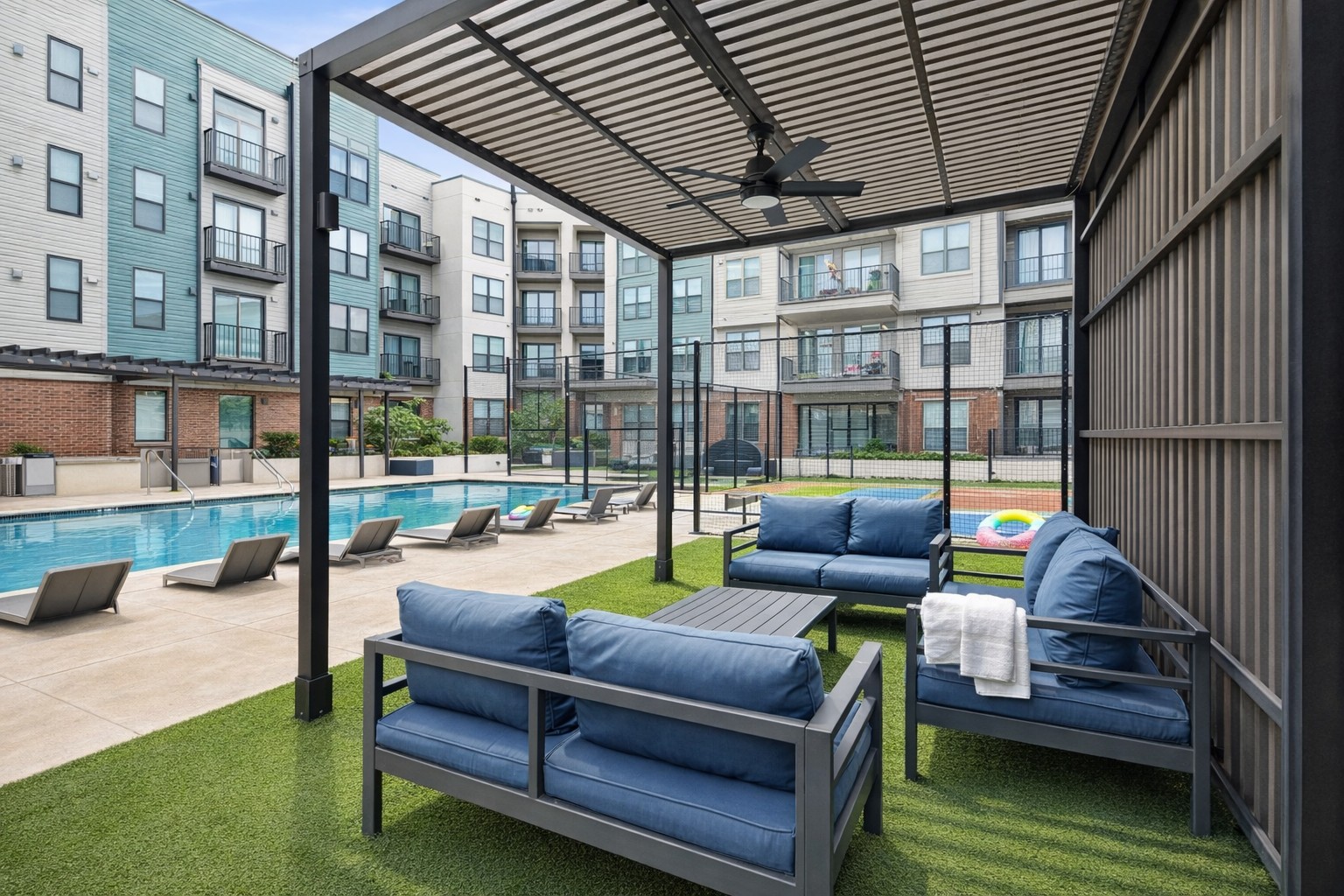 Shaded poolside lounge with blue seating